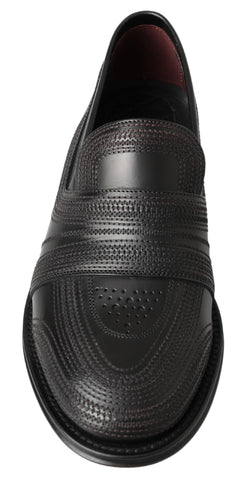 Black leather slipper loafers with stitched detailing by Dolce & Gabbana, featuring a sleek, classic design for casual or formal wear.