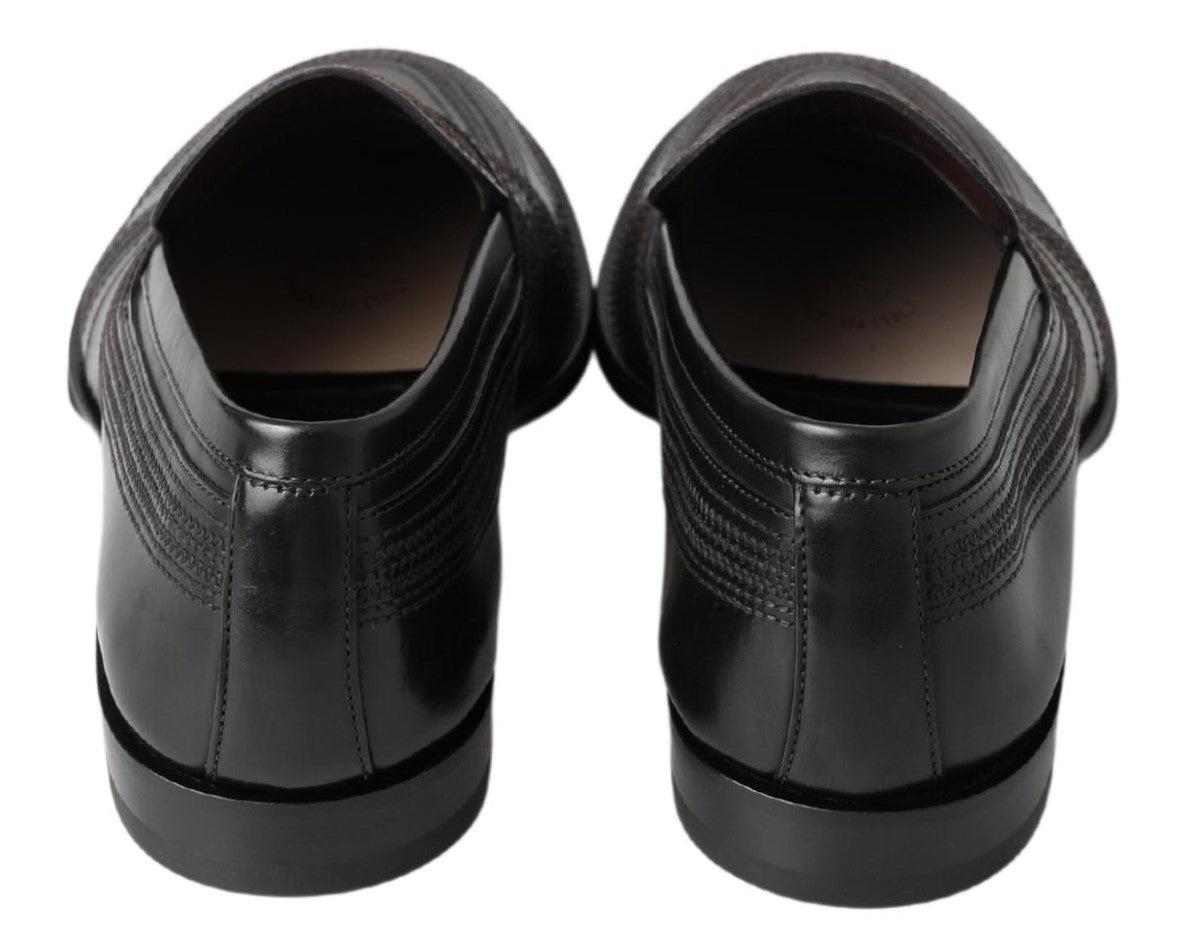 Black leather slipper loafers with stitched detailing from Dolce & Gabbana, showcasing a sleek, stylish design.