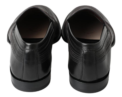 Black leather slipper loafers with stitched detailing from Dolce & Gabbana, showcasing a sleek, stylish design.