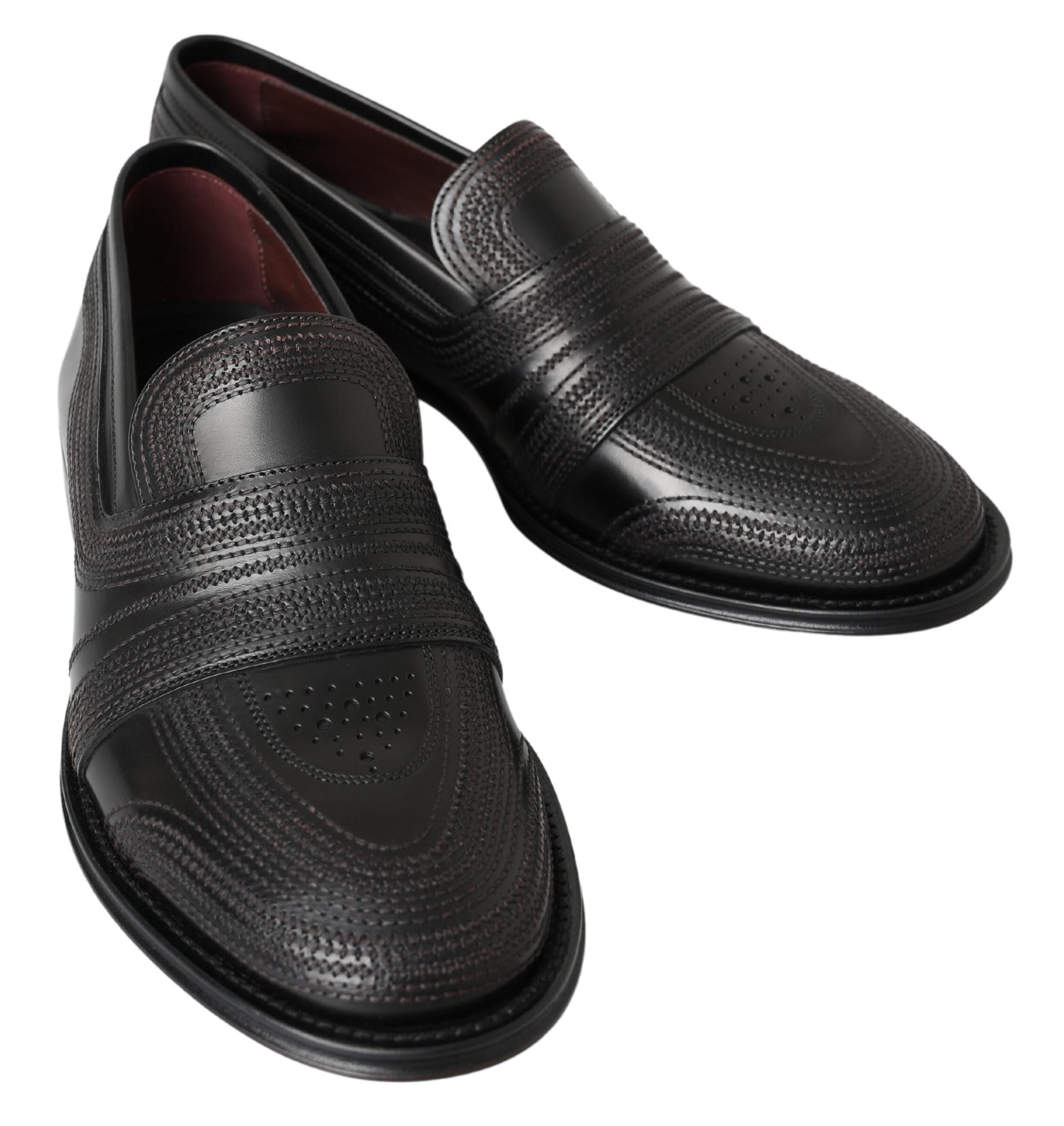 Black leather slipper loafers with stitched detailing by Dolce & Gabbana, featuring a sleek slip-on design and smooth finish.