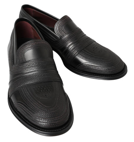 Black leather slipper loafers with stitched detailing by Dolce & Gabbana, featuring a sleek slip-on design and smooth finish.