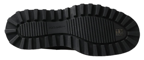 Black leather slip-on stretch boots by Dolce & Gabbana, featuring sleek design and ankle-high fit.
