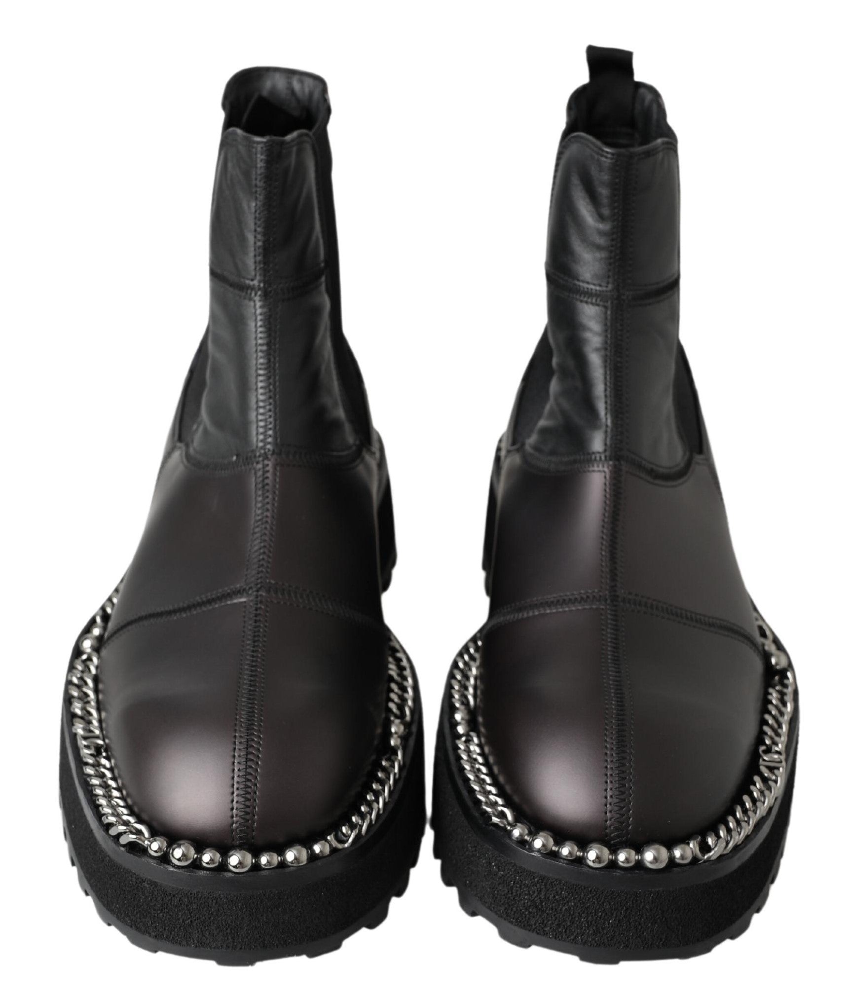 Black leather slip-on stretch boots by Dolce & Gabbana, featuring sleek design and elastic sides for a comfortable fit.