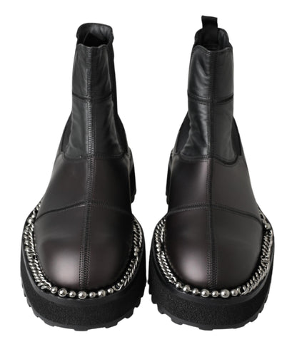 Black leather slip-on stretch boots by Dolce & Gabbana, featuring sleek design and elastic sides for a comfortable fit.