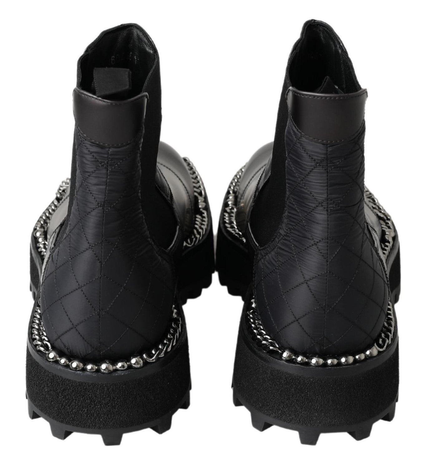 Black leather slip-on stretch boots by Dolce & Gabbana with sleek design and elastic sides, shown on a model.