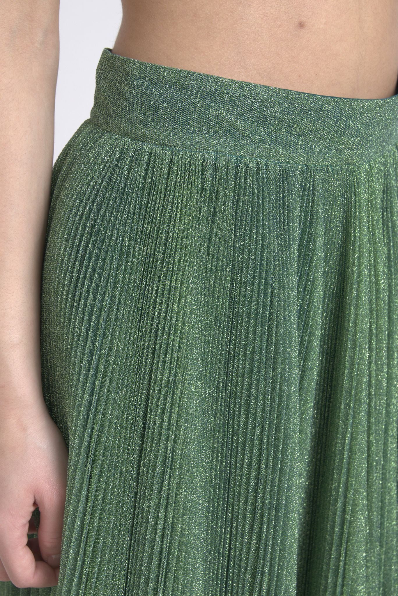 Metallic green high waist A-line pleated skirt by Dolce & Gabbana, shown with flowing pleats and shiny fabric.