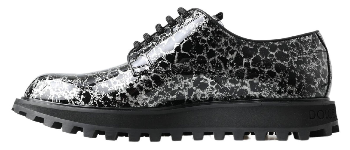 Black and white Dolce & Gabbana derby shoes in patent leather with classic design and sleek finish.