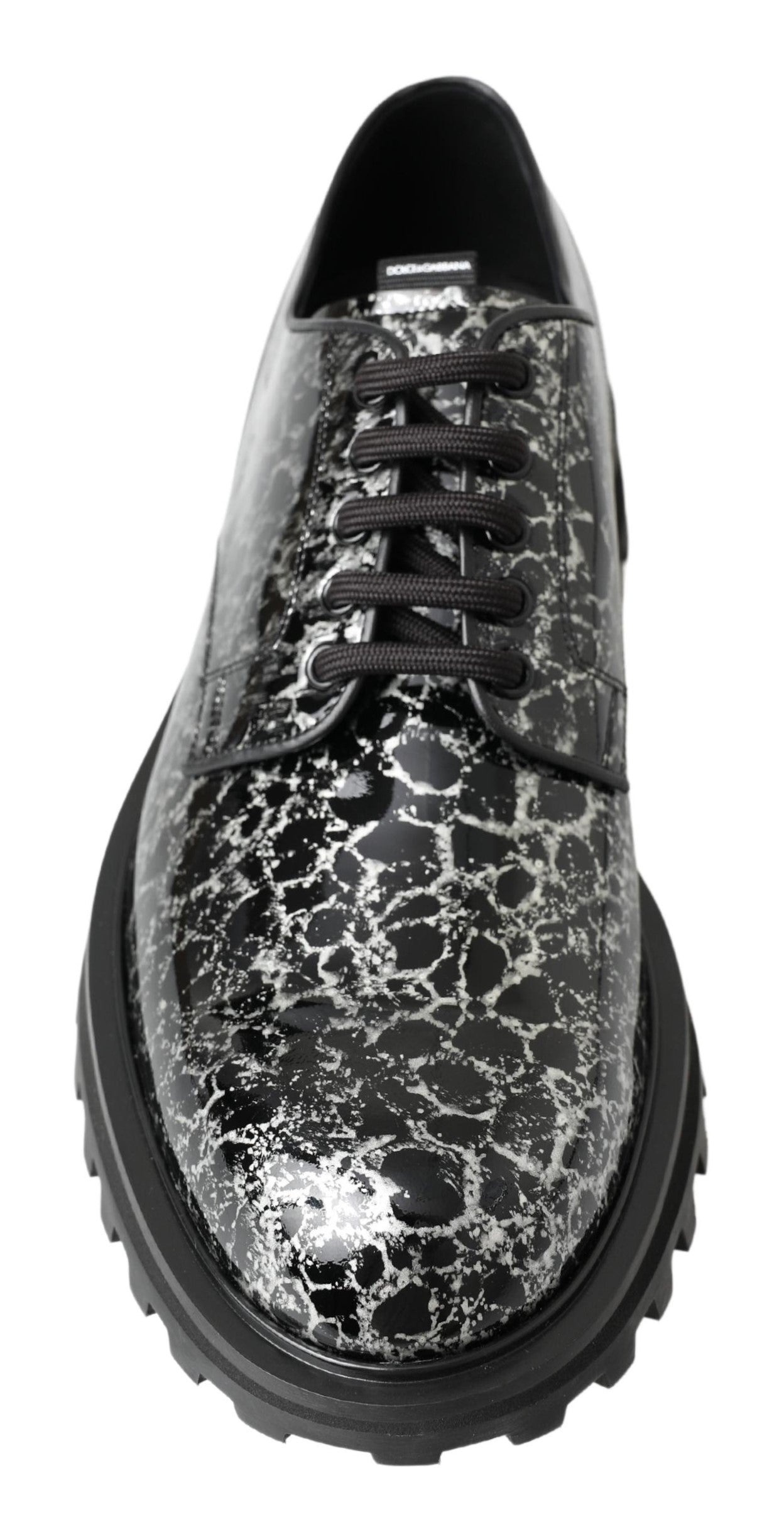 Black and white patent leather derby shoes by Dolce & Gabbana, with sleek design and polished finish.