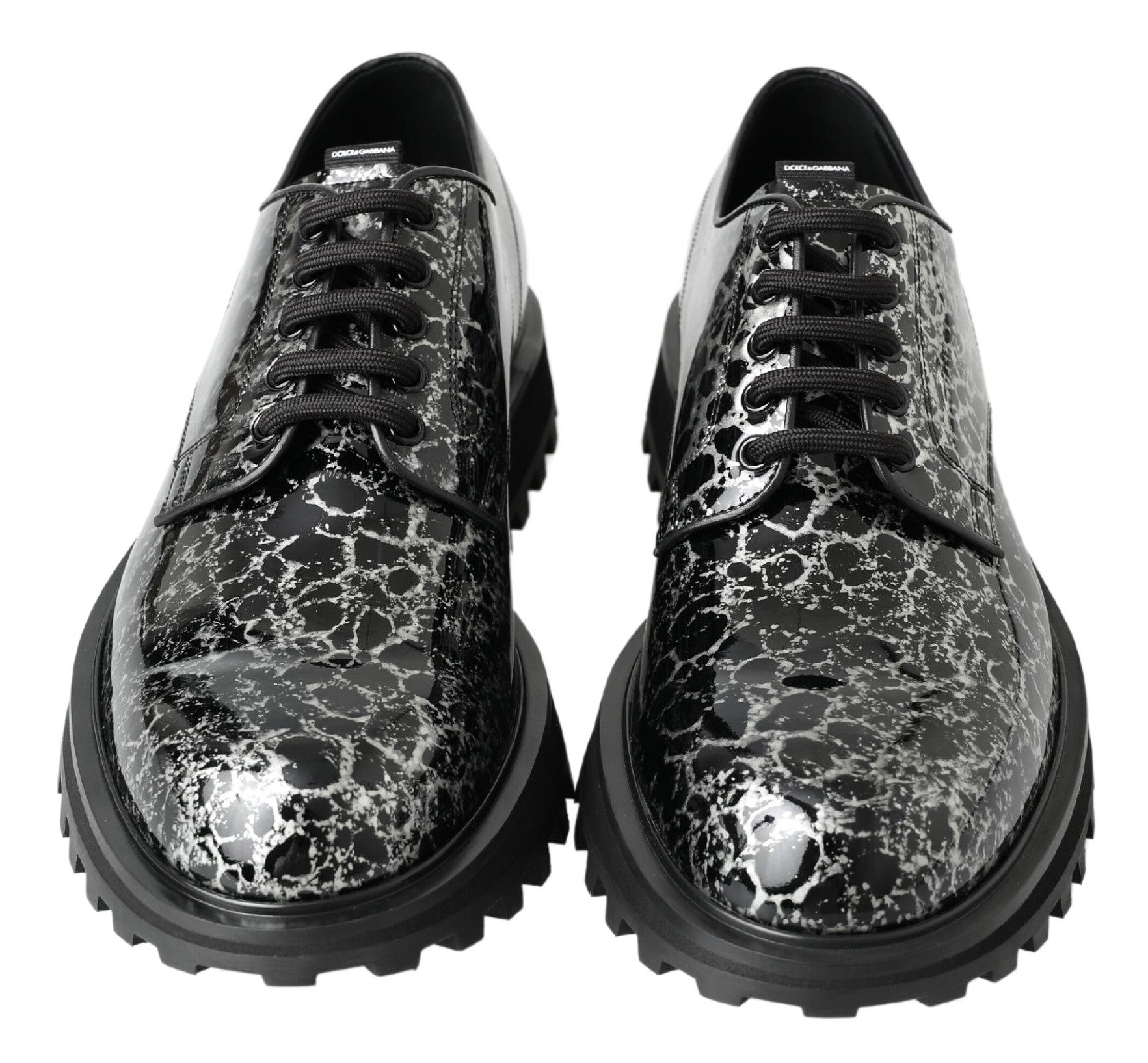 Black and white patent leather derby shoes by Dolce & Gabbana, featuring classic design and polished finish.