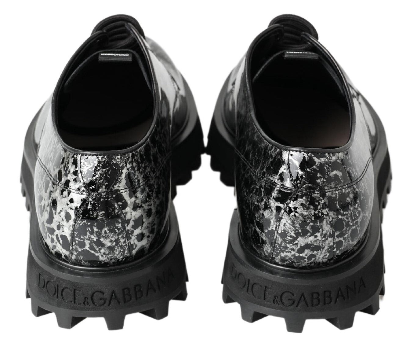 Black and white patent leather derby shoes by Dolce & Gabbana, featuring a classic design and sleek finish.