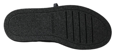 Black leather slip-on stretch boots by Dolce & Gabbana, featuring sleek design and smooth texture.