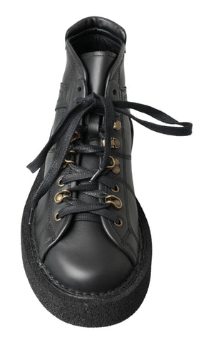 Black leather slip-on stretch boots by Dolce & Gabbana, featuring sleek design and comfortable fit, shown from a side view.