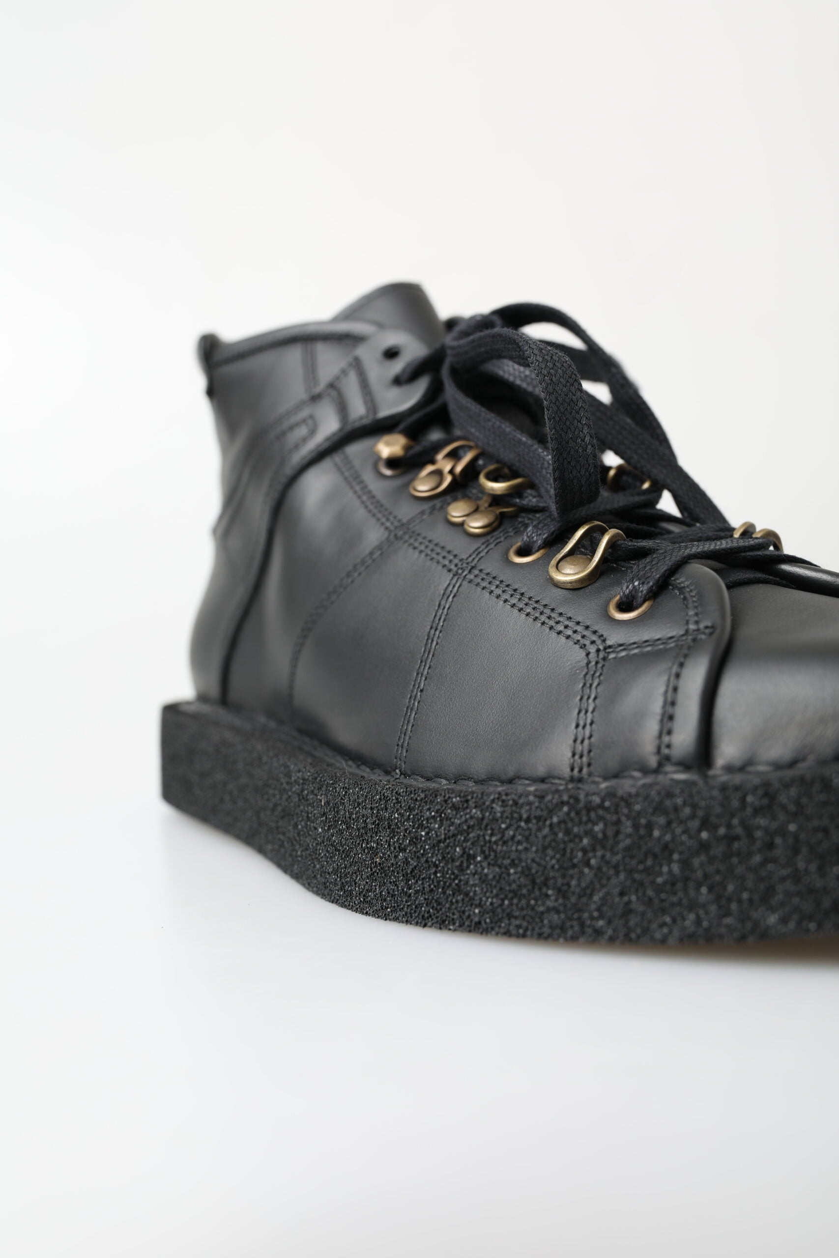 Black leather slip-on stretch boots by Dolce & Gabbana, featuring sleek design and smooth texture.