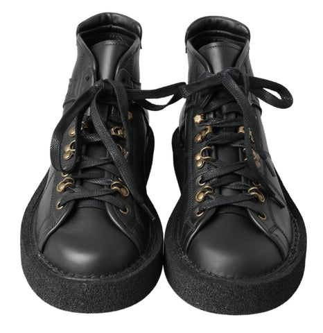 Black leather slip-on stretch boots by Dolce & Gabbana, showing sleek design and smooth texture.