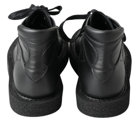 Black leather slip-on stretch boots by Dolce & Gabbana, featuring sleek design and comfortable fit.