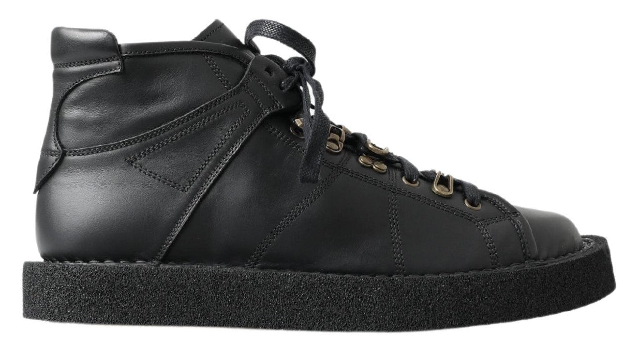 Black leather slip-on stretch boots by Dolce & Gabbana, featuring sleek design and elastic sides.