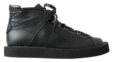 Black leather slip-on stretch boots by Dolce & Gabbana, featuring sleek design and elastic sides.