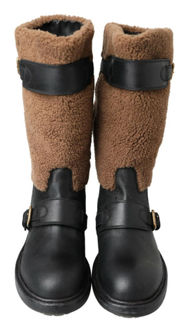 Black leather and brown shearling boots by Dolce & Gabbana with lace-up front and rugged sole.