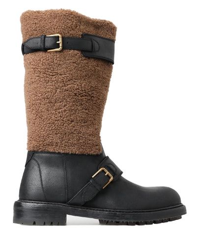 Black leather and brown shearling Dolce & Gabbana boots with lace-up front and rugged sole.