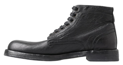 Black leather Perugino boots by Dolce & Gabbana featuring sleek design, pointed toe, and ankle-high style.
