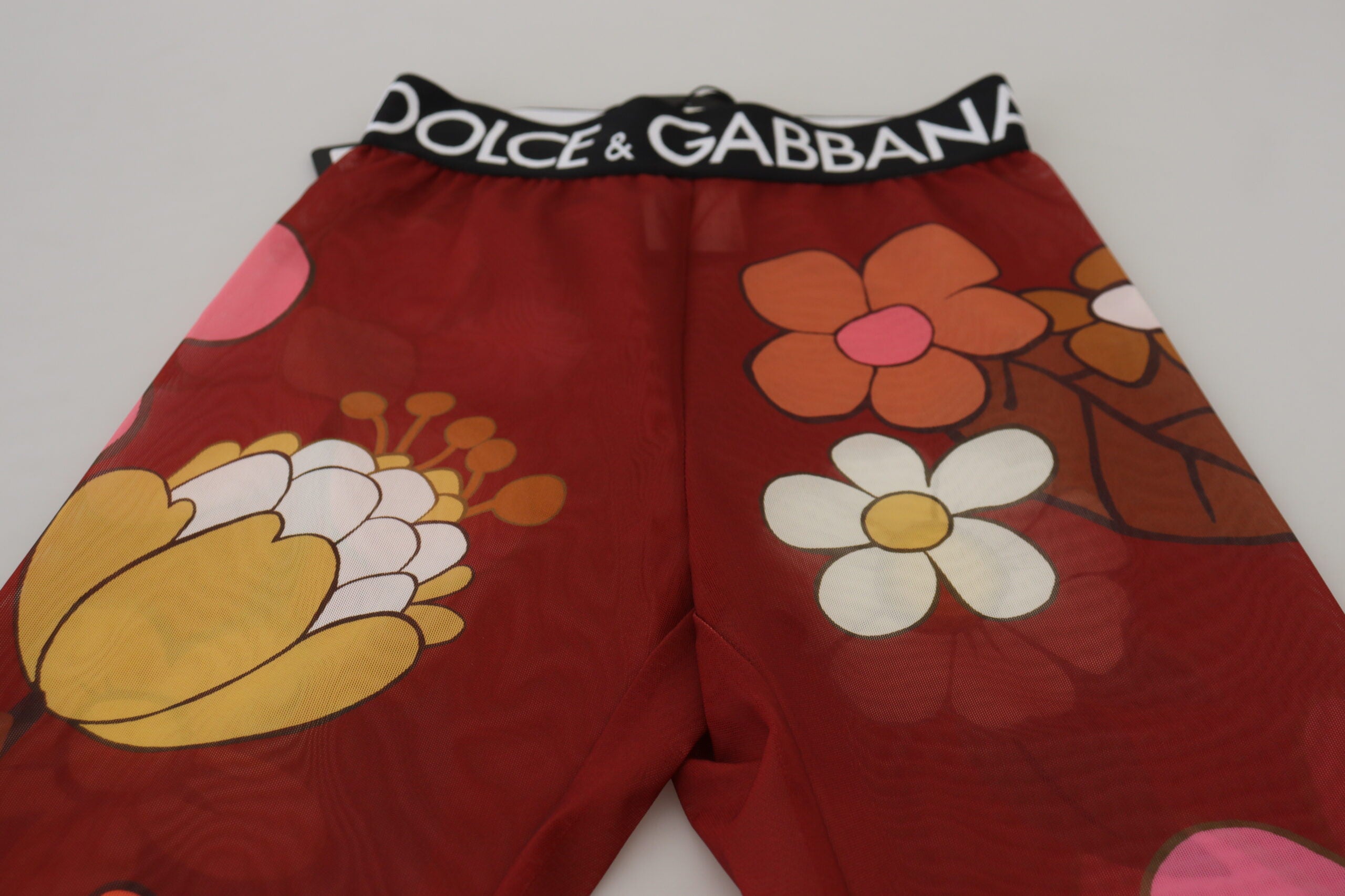 Red floral Dolce & Gabbana leggings with stretchy waist and fitted design, showcasing vibrant floral pattern and comfortable fit.