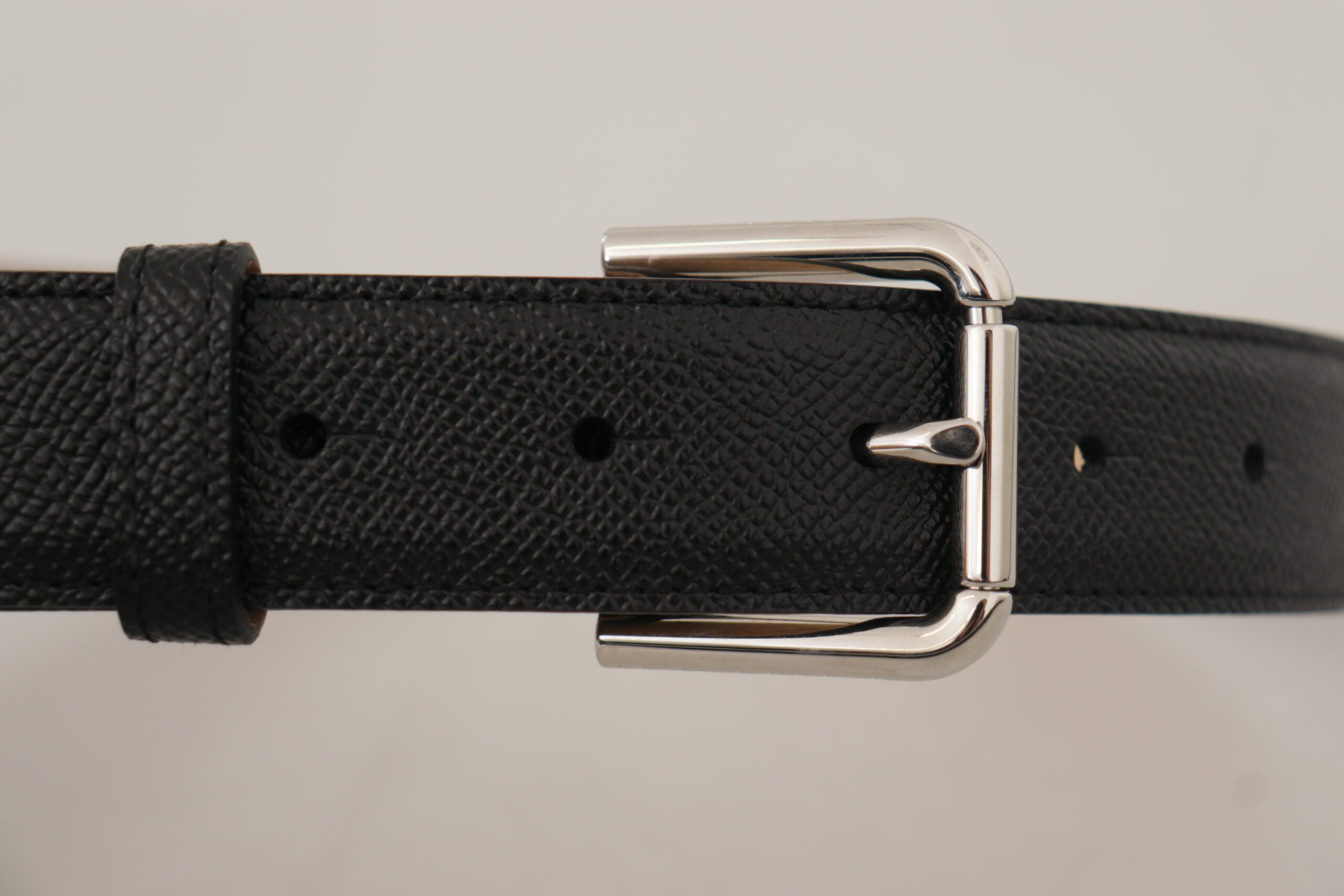 Black calf leather belt with brown backend and metal buckle from Dolce & Gabbana, featuring a sleek and stylish design.