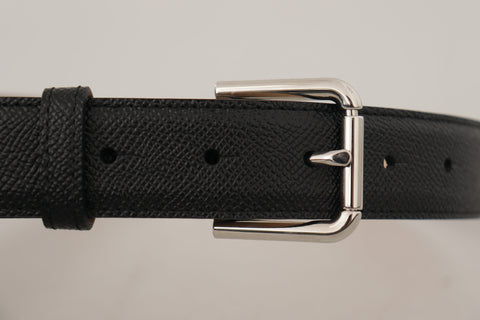 Black calf leather belt with brown backend and metal buckle from Dolce & Gabbana, featuring a sleek and stylish design.