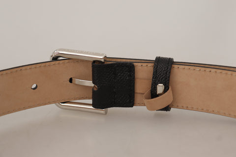 Black calf leather belt with brown backend and metal buckle from Dolce & Gabbana, featuring a sleek and stylish design.
