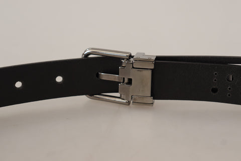 Black calf leather belt with perforated design and metal buckle by Dolce & Gabbana, displayed on a neutral background.