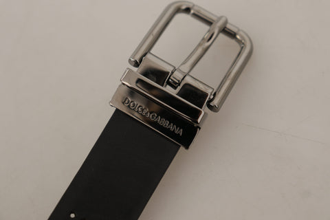 Black calf leather belt with perforated design and metal buckle from Dolce & Gabbana, showcasing its stylish craftsmanship.