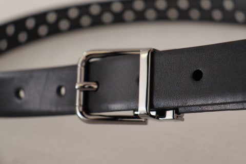 Black calf leather belt with perforated design and metal buckle from Dolce & Gabbana, shown with close-up detail.