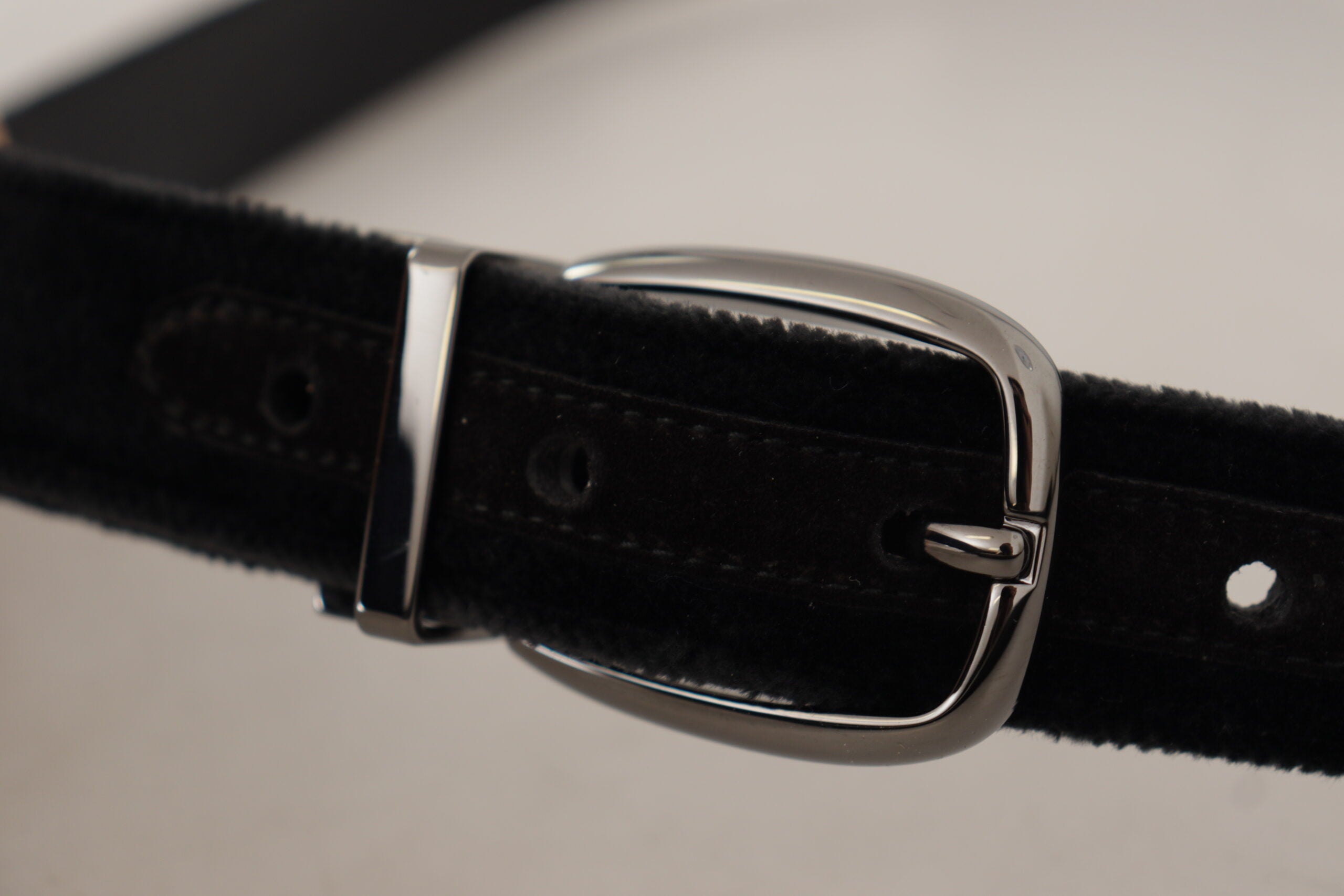 Black velvet Dolce & Gabbana belt with engraved metal logo, featuring a classic design and silver-tone buckle.