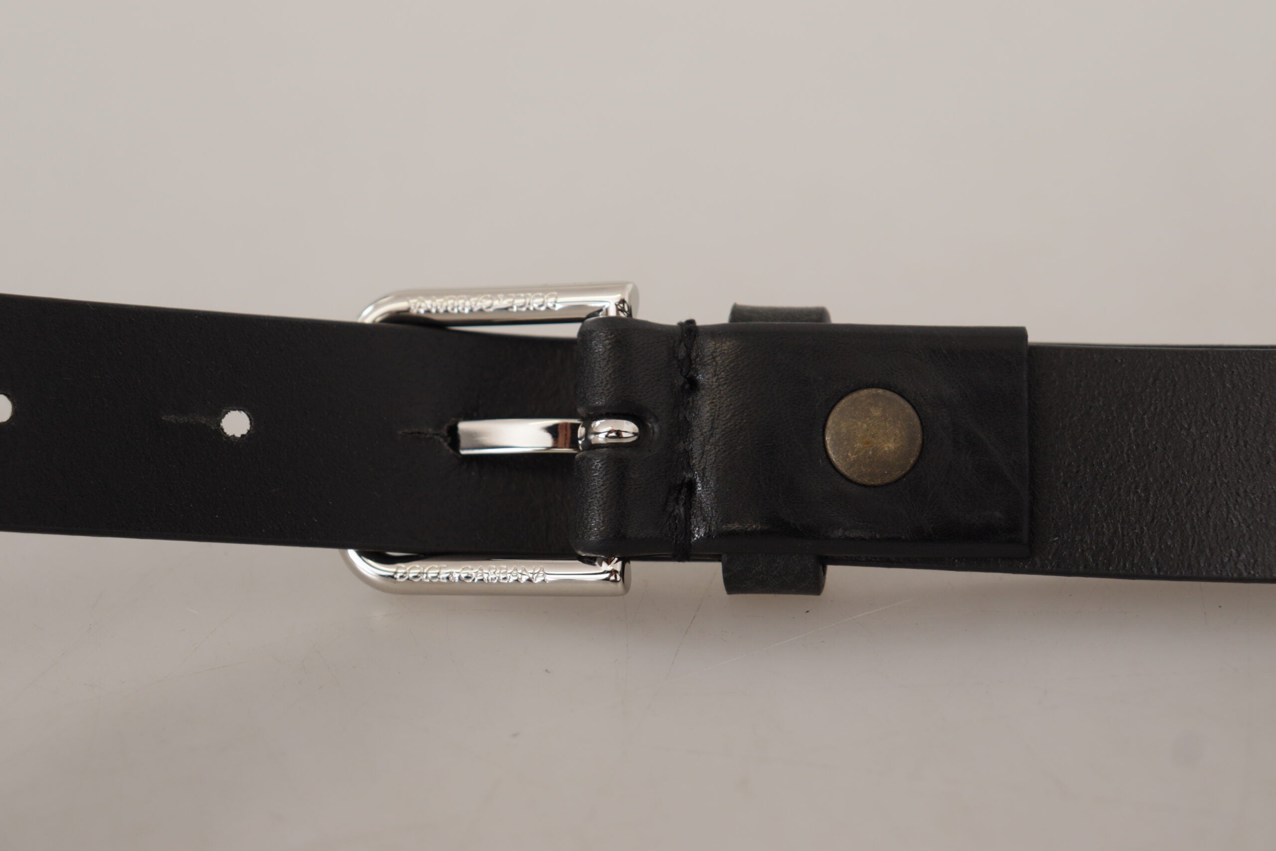 Black calf leather belt by Dolce & Gabbana with silver-tone logo metal buckle, featuring a sleek, stylish design.