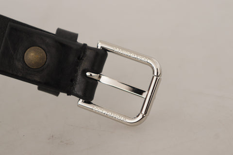 Black calf leather belt with silver tone logo metal buckle by Dolce & Gabbana, featuring a sleek and stylish design.