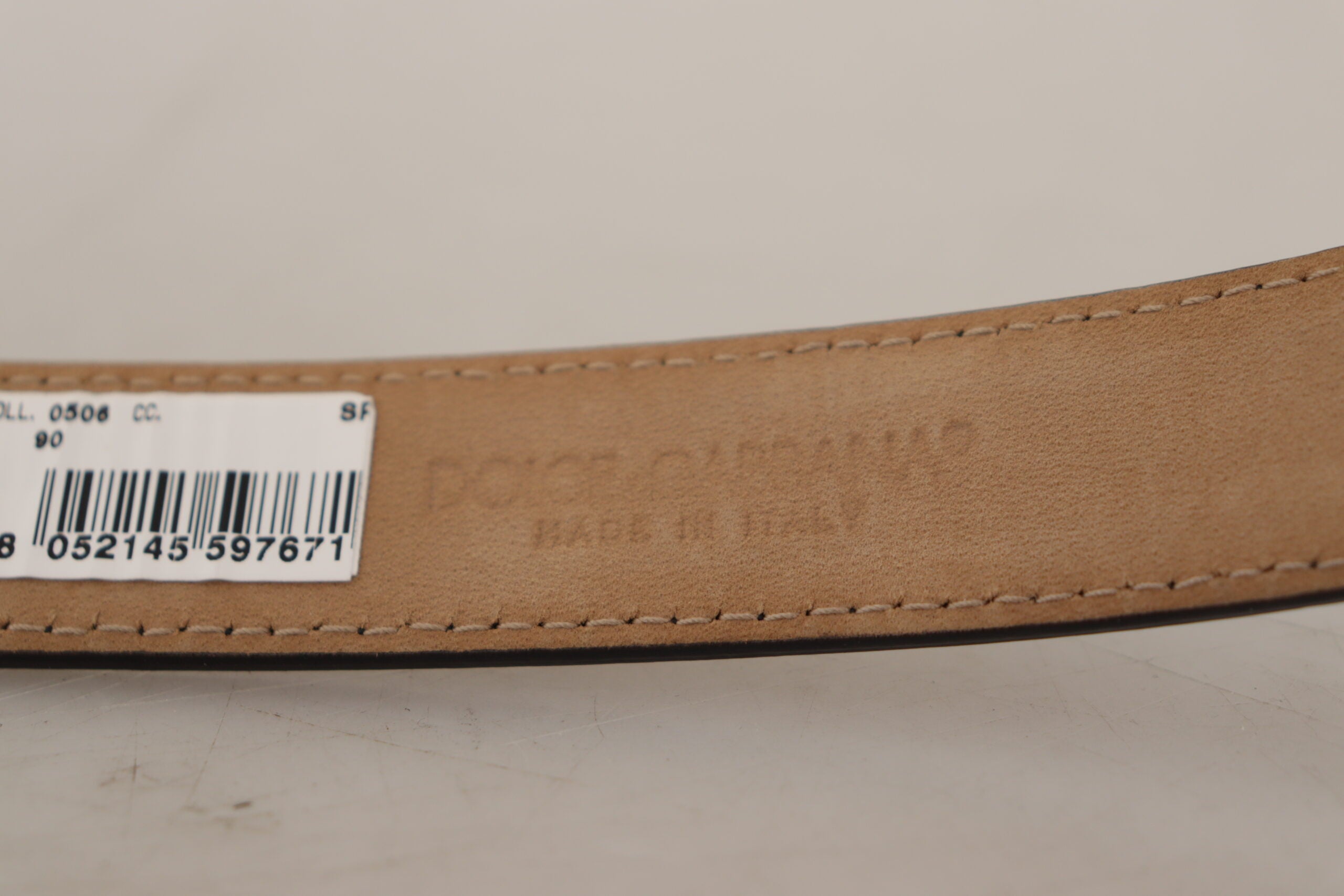 Black calf leather belt with engraved metal buckle featuring Dolce & Gabbana logo, stylish accessory for men.