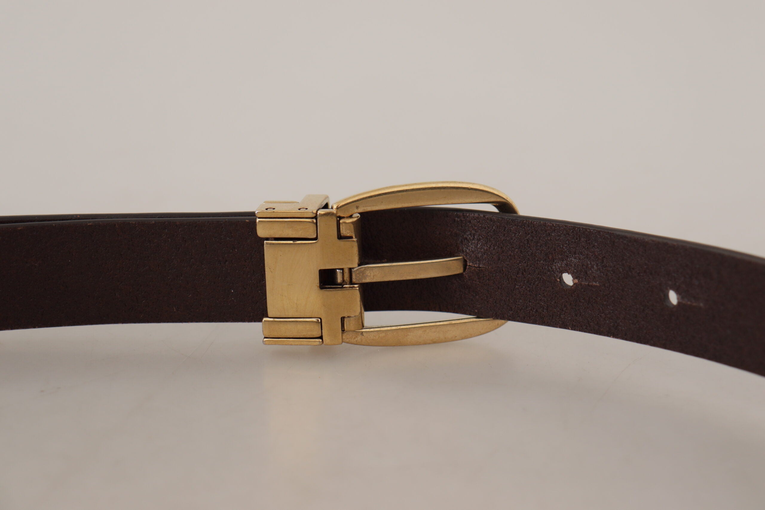Dark brown calf leather belt with gold tone metal buckle from Dolce & Gabbana, featuring a sleek and polished design.