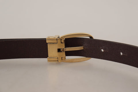 Dark brown calf leather belt with gold tone metal buckle from Dolce & Gabbana, featuring a sleek and polished design.