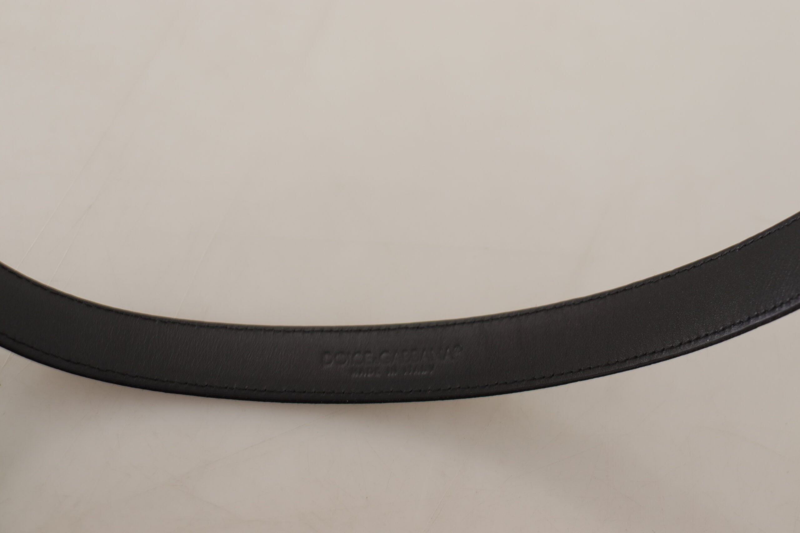 Black calf leather belt with silver logo metal buckle from Dolce & Gabbana, featuring a sleek and polished design.
