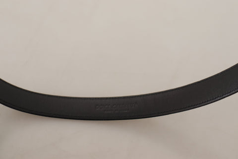 Black calf leather belt with silver logo metal buckle from Dolce & Gabbana, featuring a sleek and polished design.