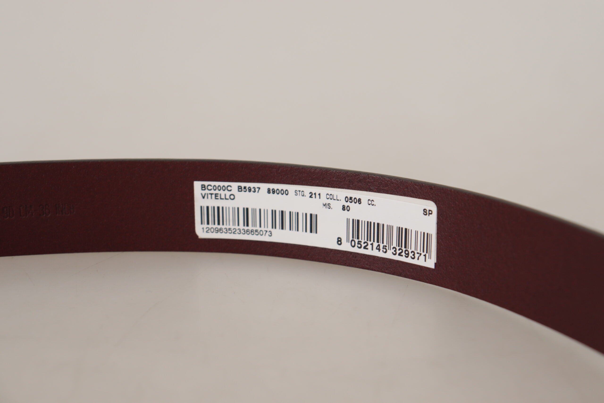 Maroon calf leather belt with silver tone metal buckle from Dolce & Gabbana, showing the detailed buckle and smooth leather strap.