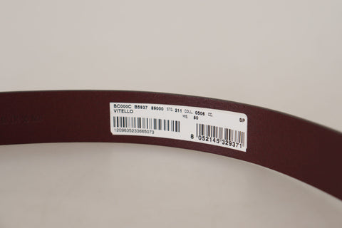 Maroon calf leather belt with silver tone metal buckle from Dolce & Gabbana, showing the detailed buckle and smooth leather strap.
