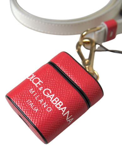 Red leather AirPods case with gold tone metal logo print by Dolce & Gabbana, stylish protective accessory for wireless earbuds.