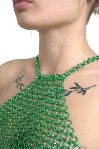 Green aluminum sleeveless halter cropped tank top by Dolce & Gabbana, shown on a mannequin with a fitted style and halter neckline.
