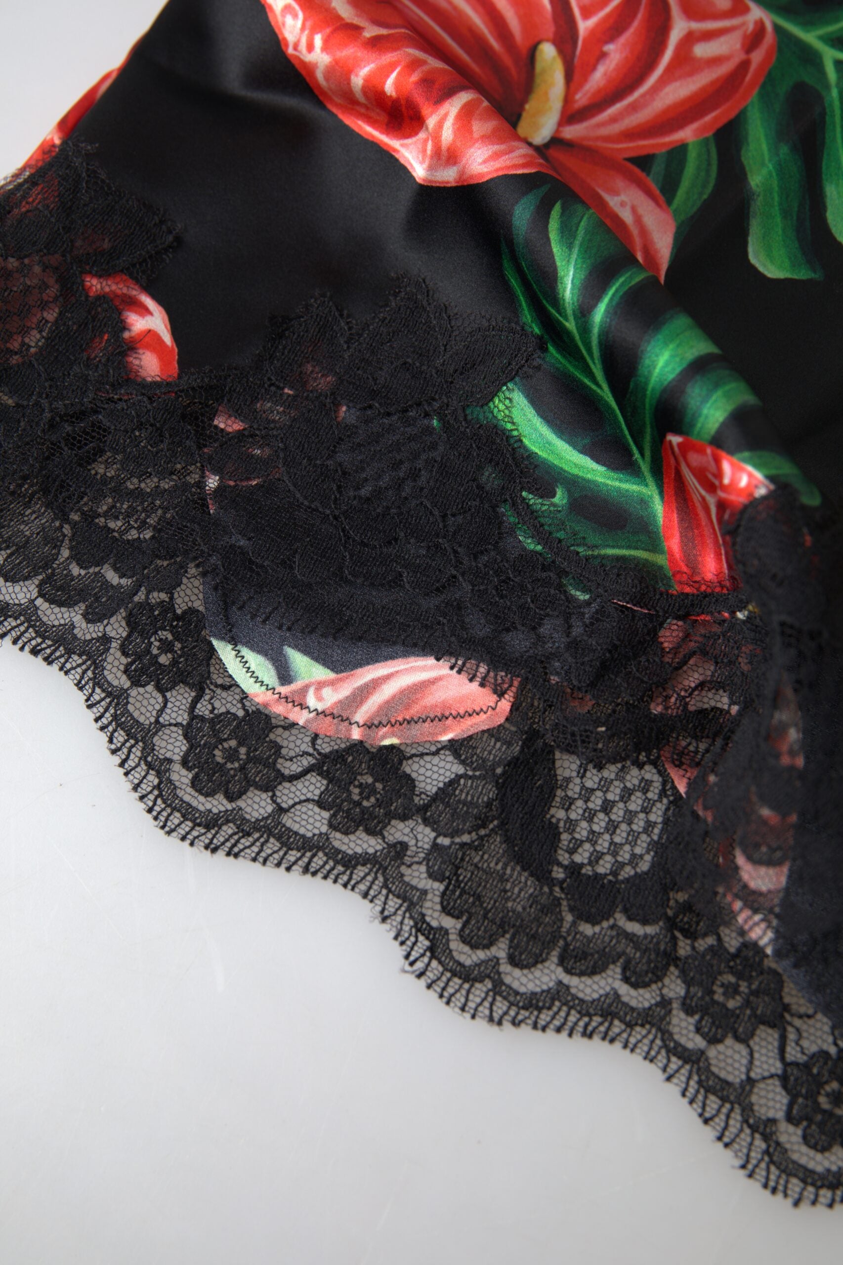 Black silk camisole top with an anthurium print from Dolce & Gabbana, featuring delicate straps and elegant floral details.