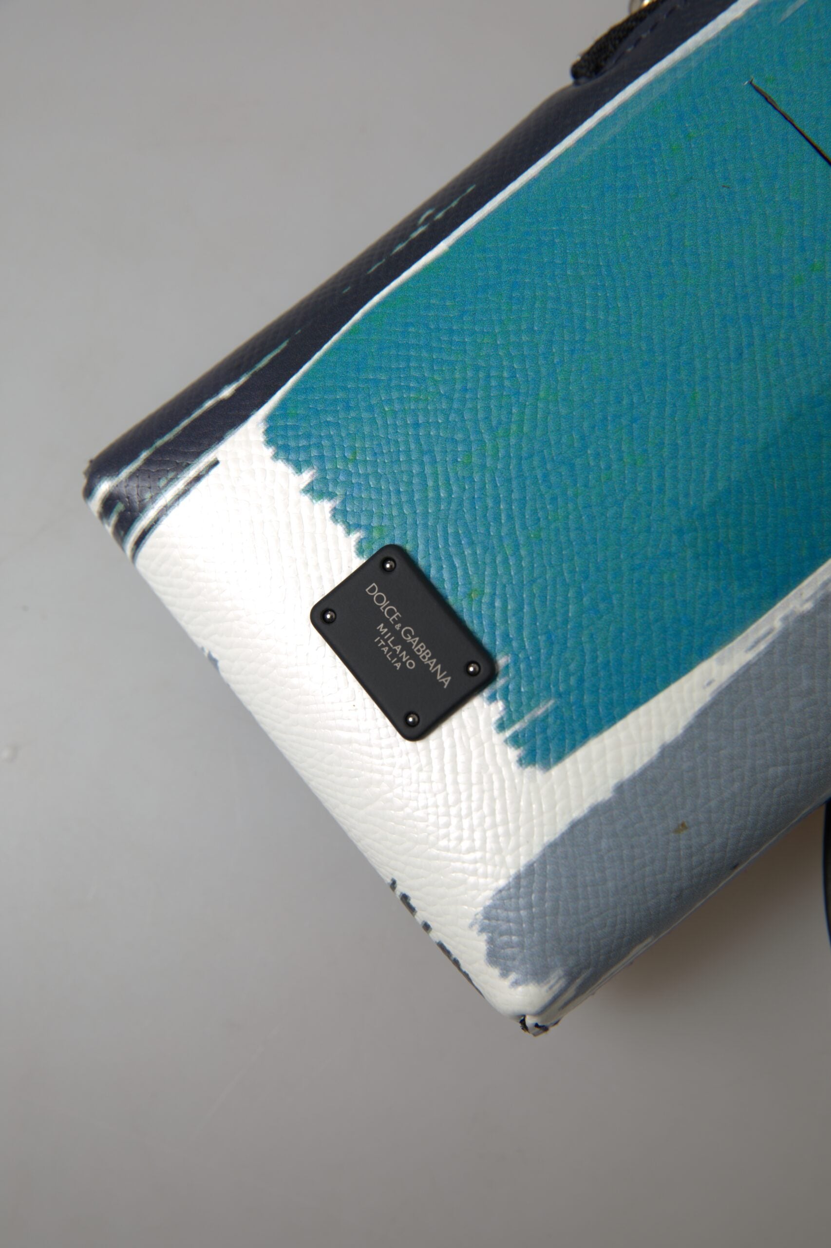 Blue leather Dolce & Gabbana crossbody purse with sling strap, unisex phone bag, compact and stylish accessory.