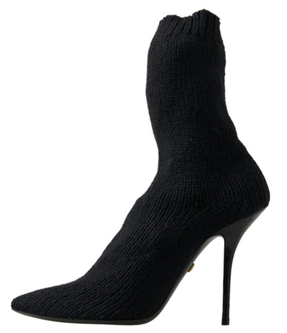 Black Dolce & Gabbana stiletto heel mid-calf women’s boot with sleek design and pointed toe, showcased from the side.