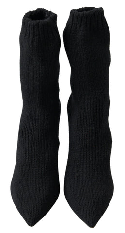 Black stiletto heel mid-calf women’s boot by Dolce & Gabbana, featuring sleek design and pointed toe.