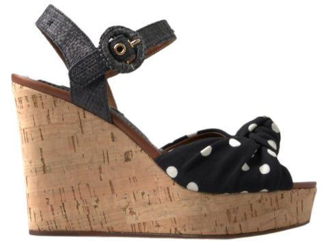 Black polka dotted wedge sandals with ankle strap from Dolce & Gabbana, featuring a stylish open-toe design.