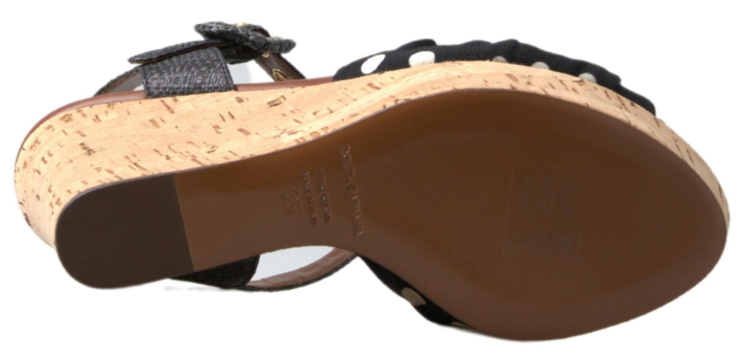 Black polka dotted wedge sandals with ankle straps by Dolce & Gabbana, featuring a stylish open-toe design and comfortable heel.