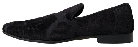 Black brocade loafers by Dolce & Gabbana with formal shoe design, featuring intricate fabric patterns and stylish slip-on style.